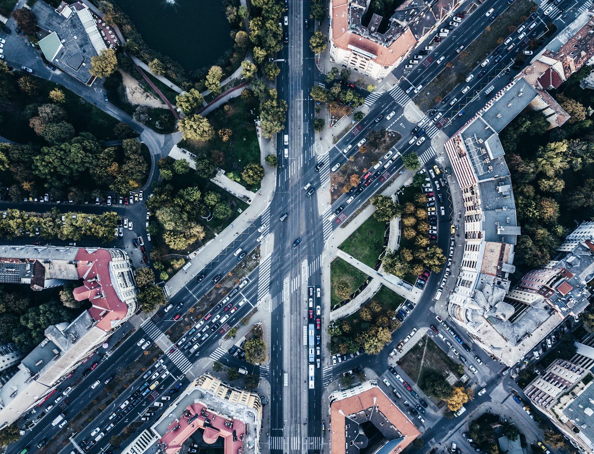 Drone shot straight down from above: intersection with road traffic and buildings