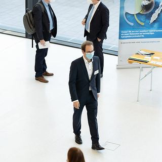 Eventfotografie Saarland: Gespräche im Foyer neben einem Ausstellerstand bei einem Fachkongress
