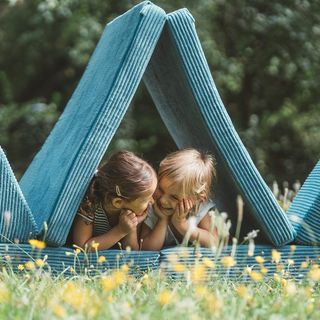 Werbefotografie Saarland: Kinder mit Spielpolstern auf einer Blumenwiese