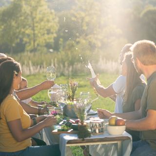 Werbefotografie für Nordisk: Freunde beim Essen an einer Tafel im Freien